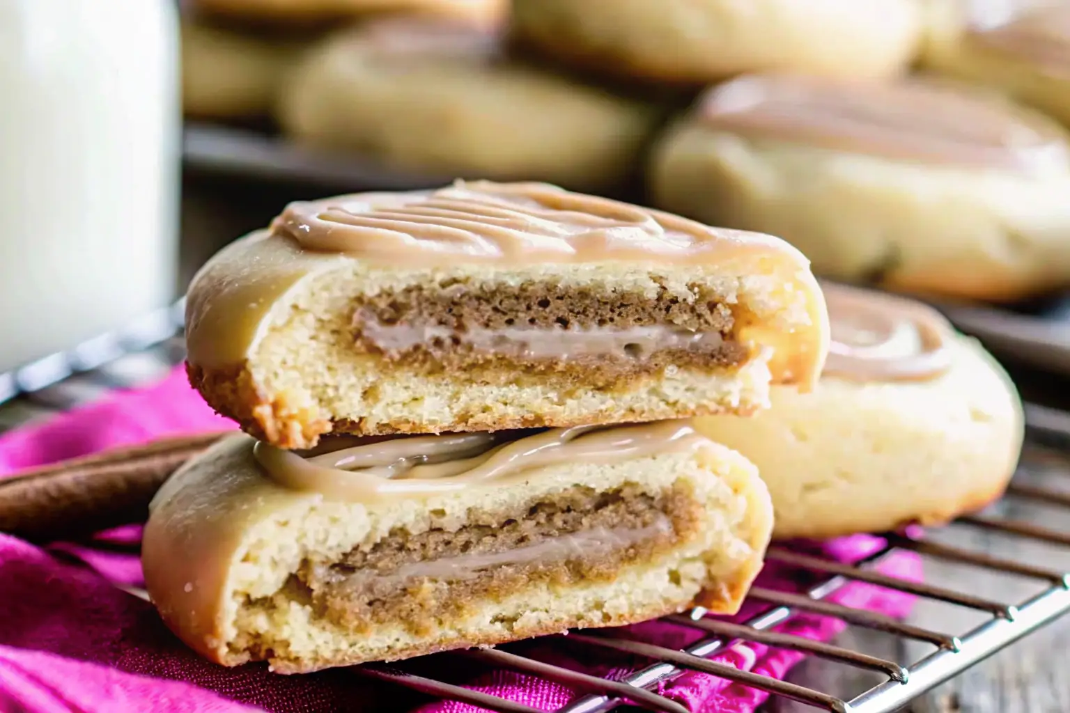 Homemade cinnamon sugar pop tart cookieswith vanilla glaze stacked on a cooling rack