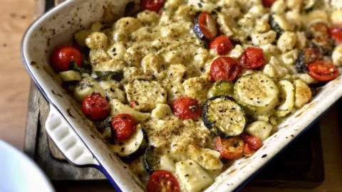 Close-up of Boursin Vegetable Bake with roasted zucchini, cherry tomatoes, and creamy cheese