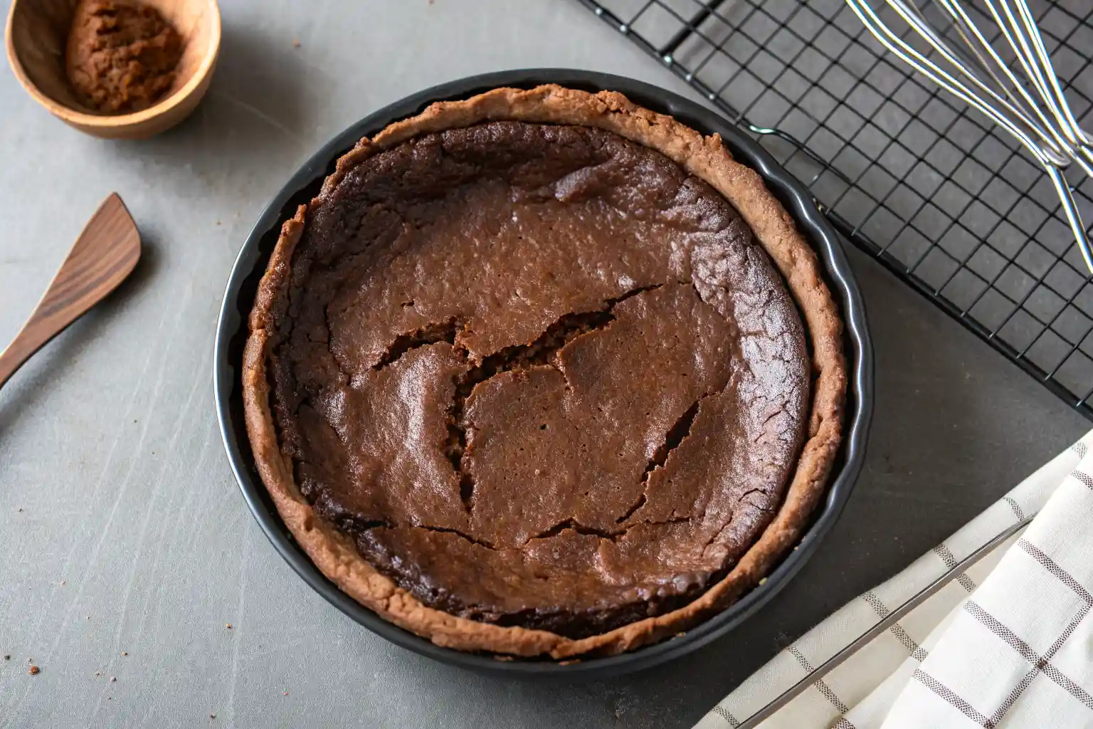 Greek Chocolate Milk Pie (Galatopia) with silky milk custard and golden top, served as a traditional Greek dessert