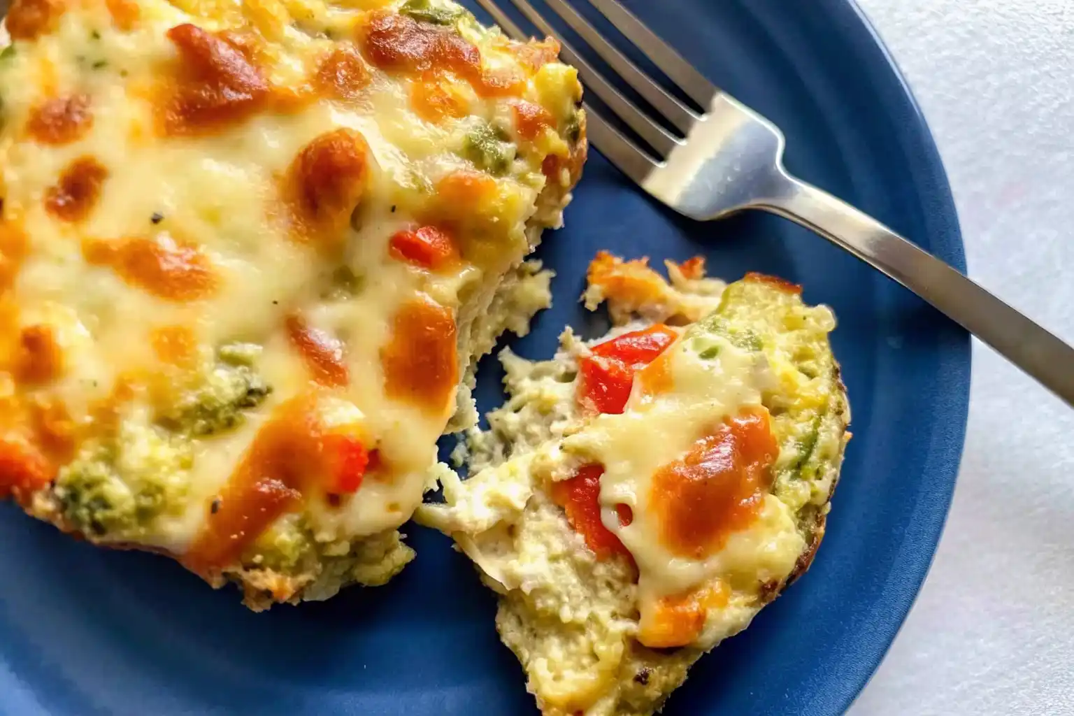 Cottage cheese veggie breakfast bars sliced into meal prep containers.
