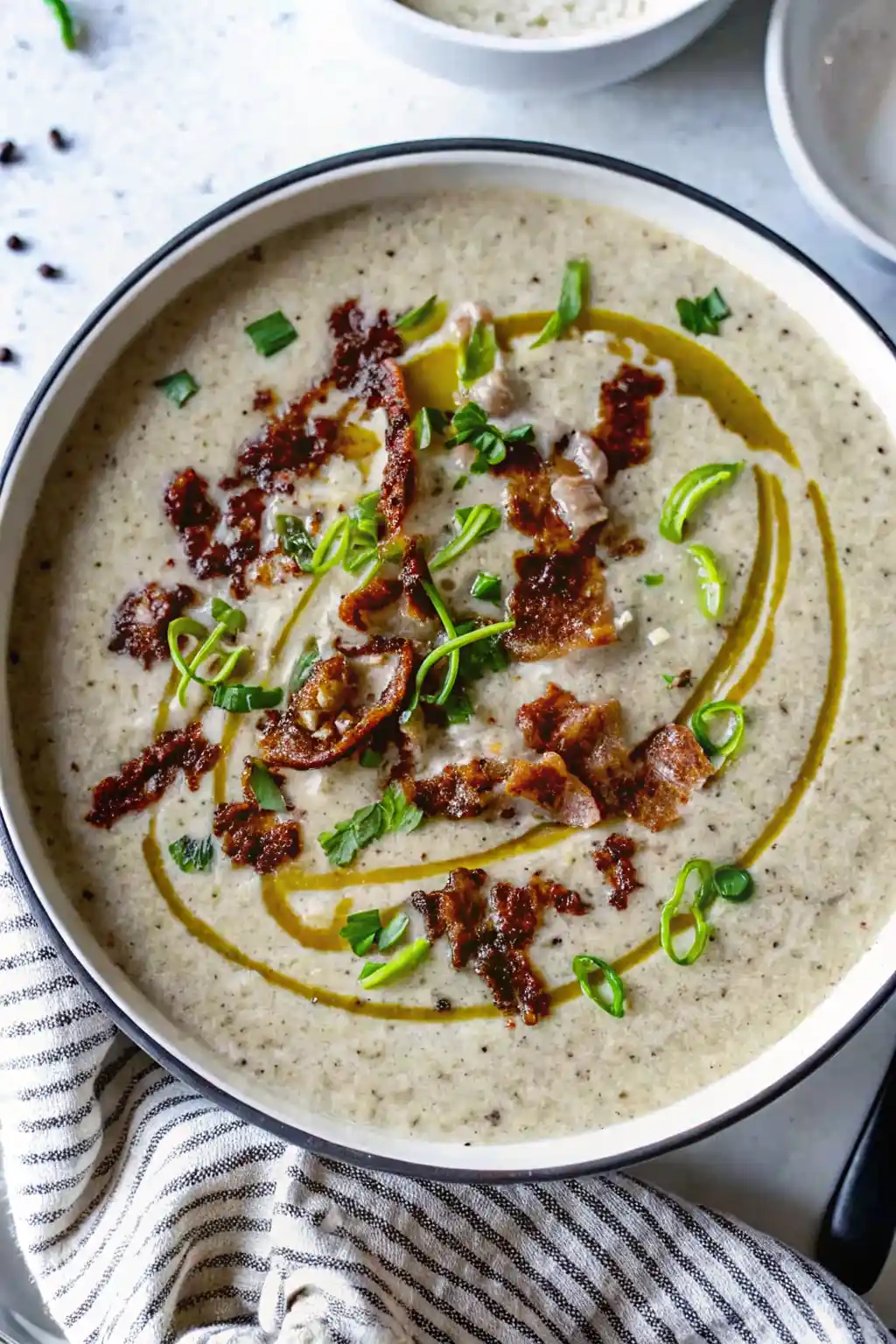 creamy roasted onion mushroom soup with caramelized onions and herbs in a ceramic bowl