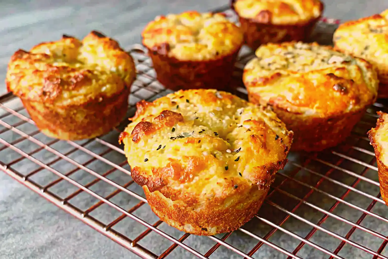 Fluffy dinner biscuits made with almond flour on a wooden tray in a cozy kitchen.