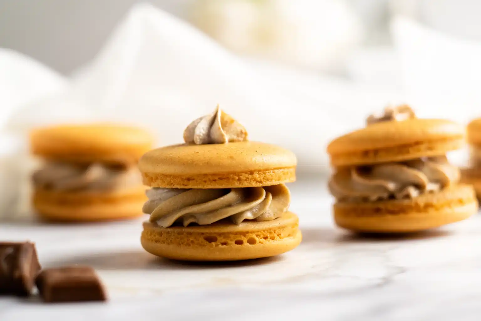 Mixing pumpkin puree and white chocolate ganache while preparing Pumpkin Pie Macarons.